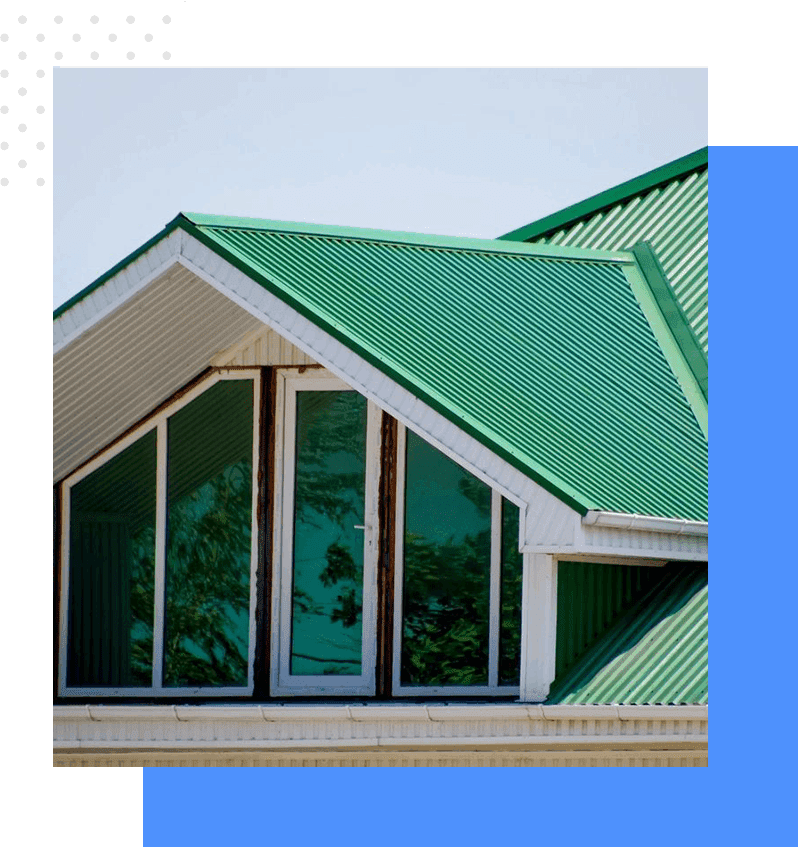 A green roof with windows and a blue sky