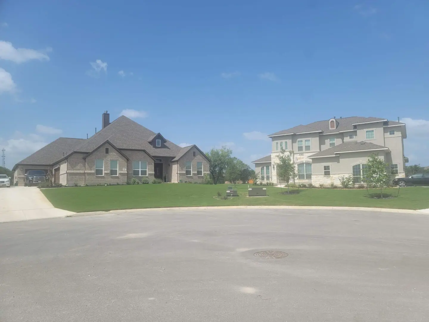 A large lot with houses in the background.