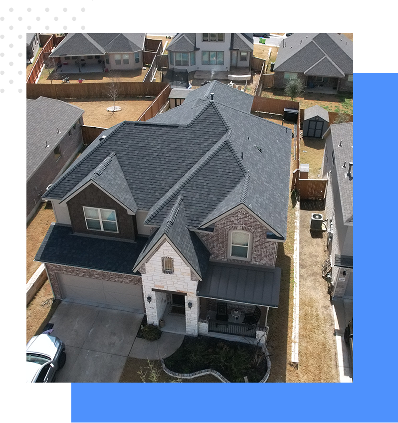A aerial view of a house with many roofs.