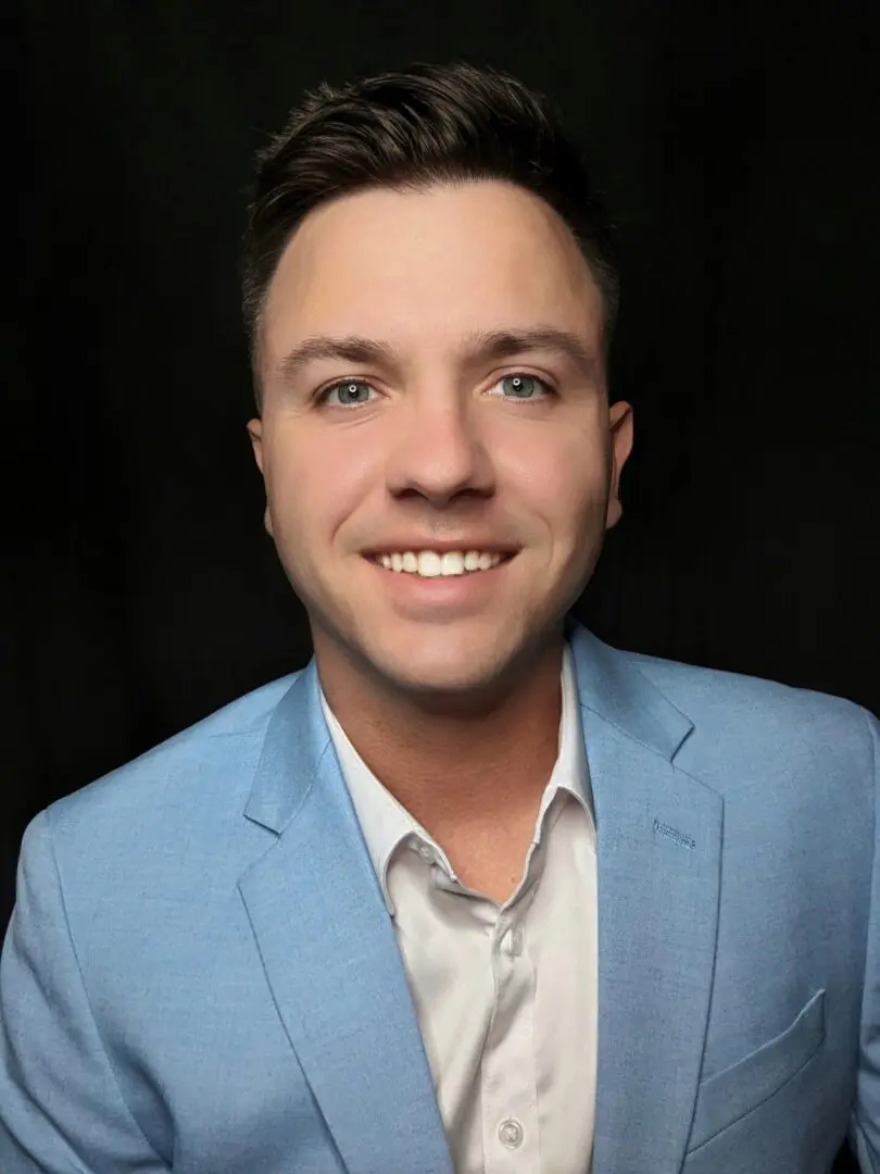 A man in a blue suit and white shirt.