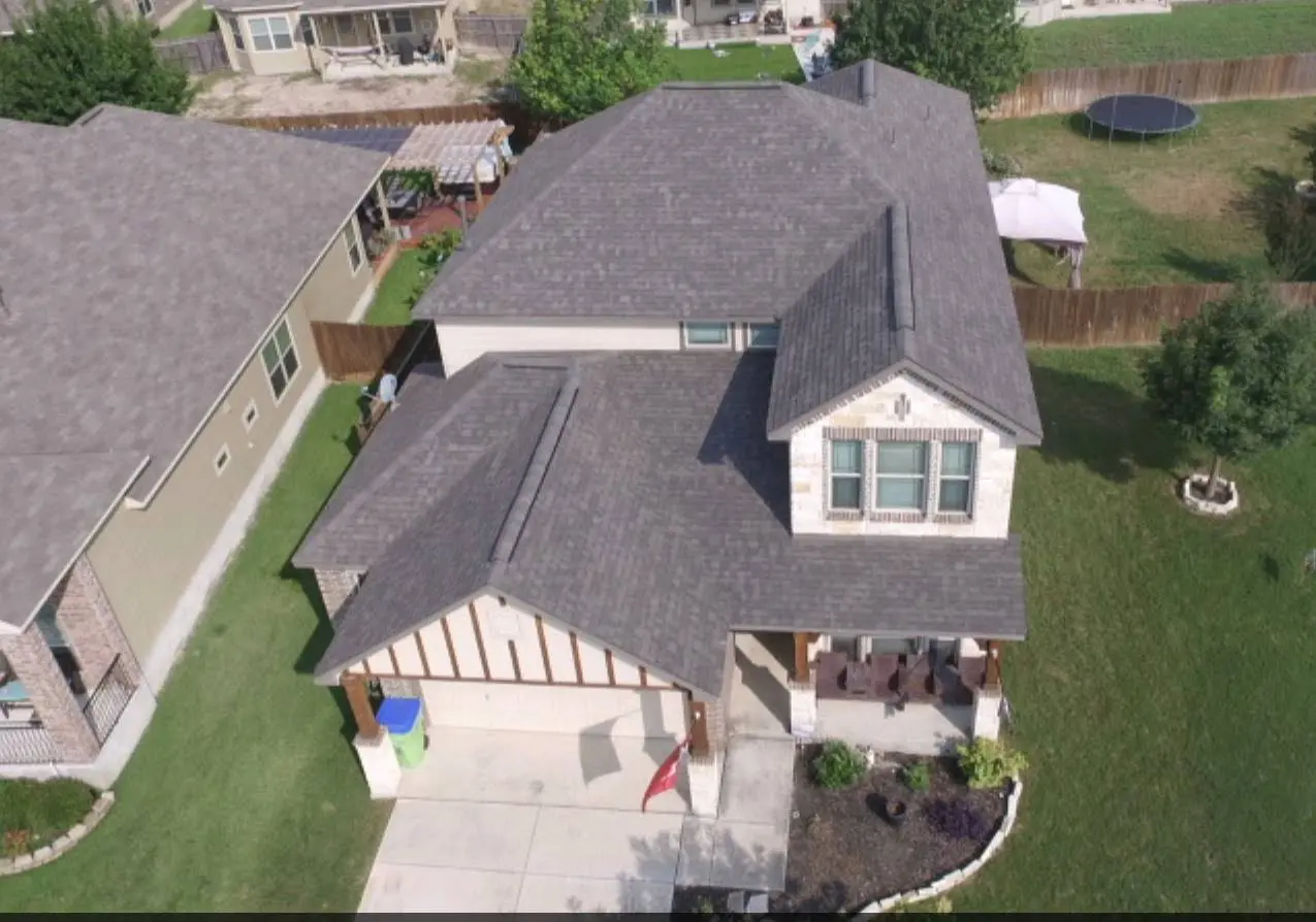 A house with a roof that has been covered in shingles.