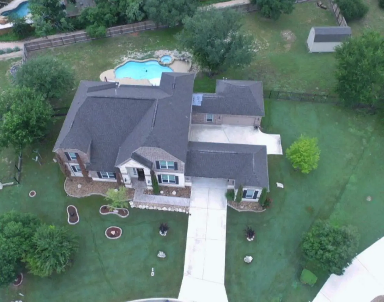 A large house with a pool in the middle of it