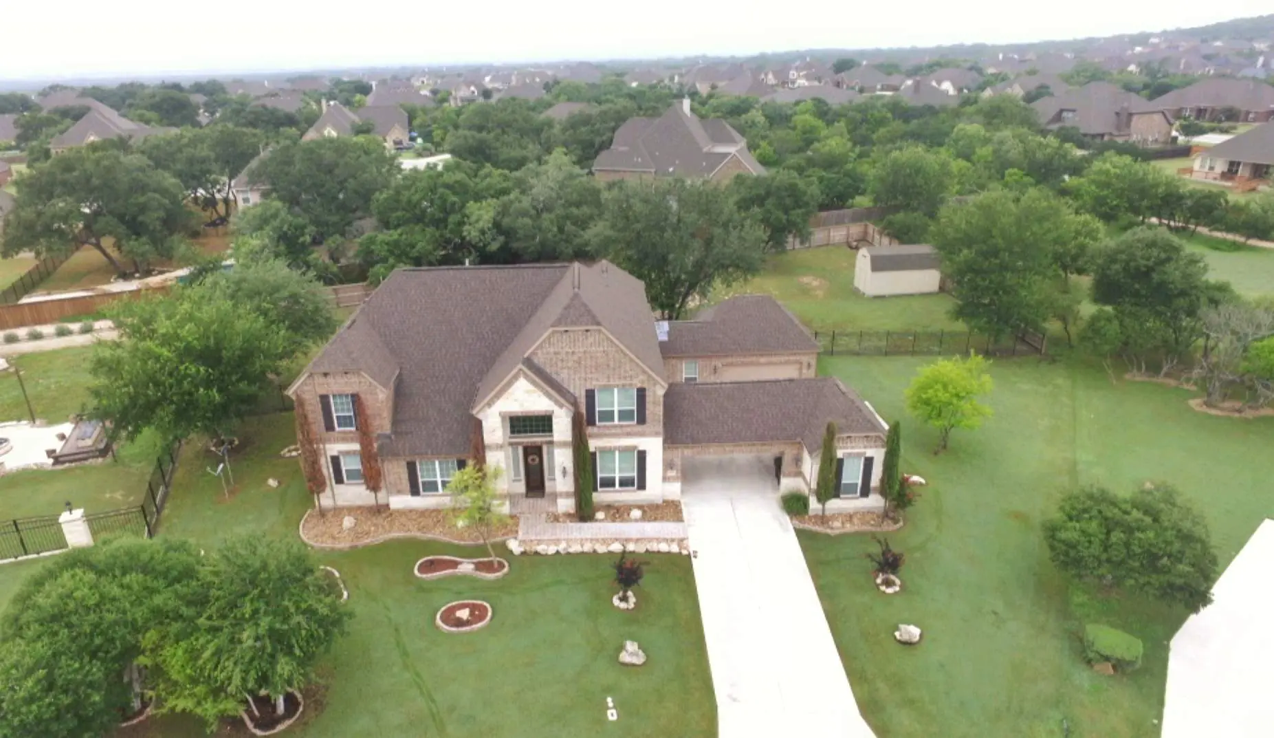 A large house with many trees in the background