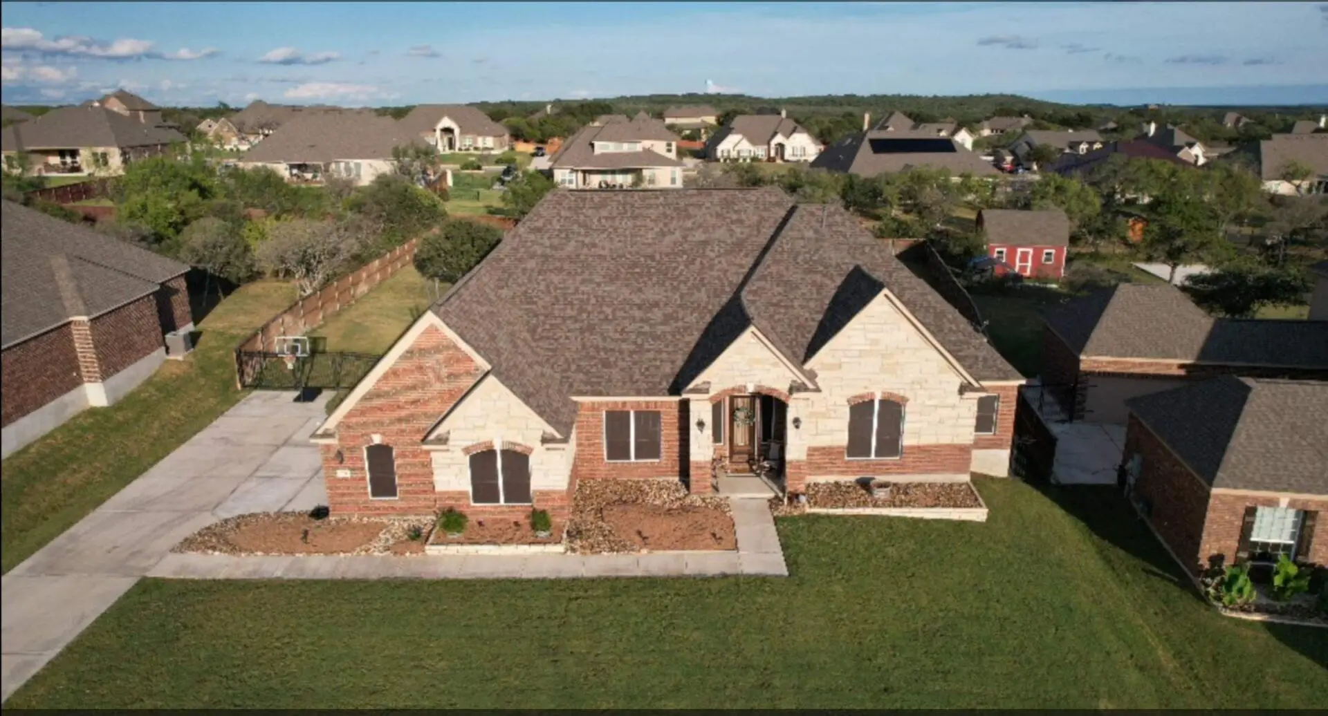 A large house with many different types of roofs.