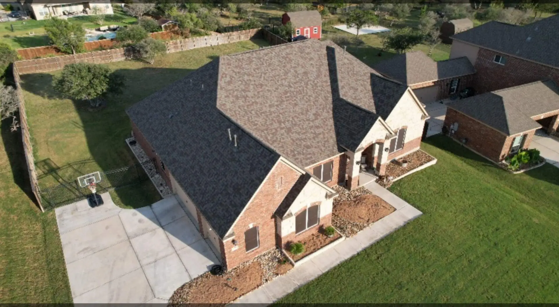 A house with a lot of windows and a roof that has been cut off.