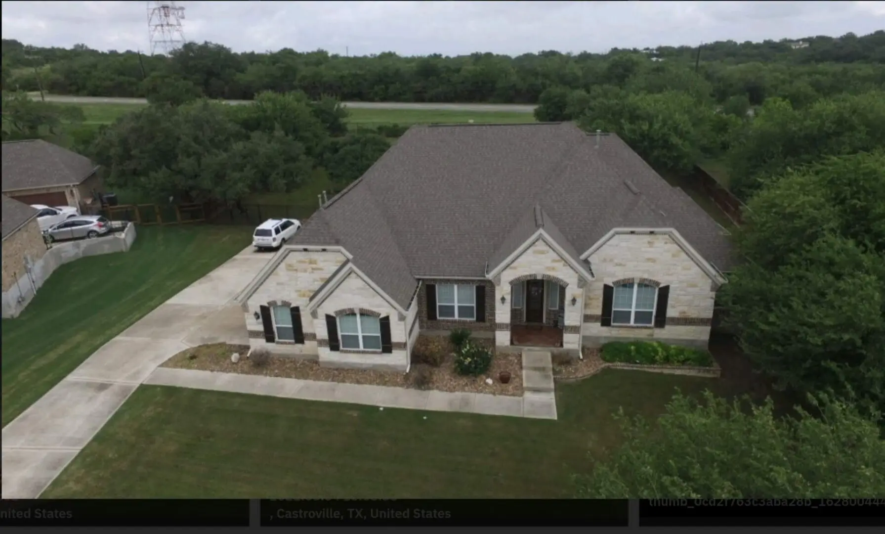 A large house with a car parked in front of it.