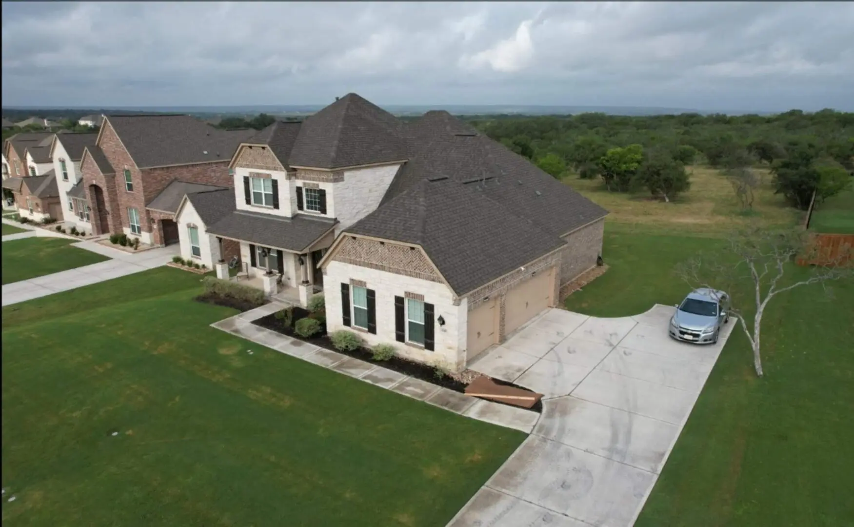 A large house with a car parked in front of it.