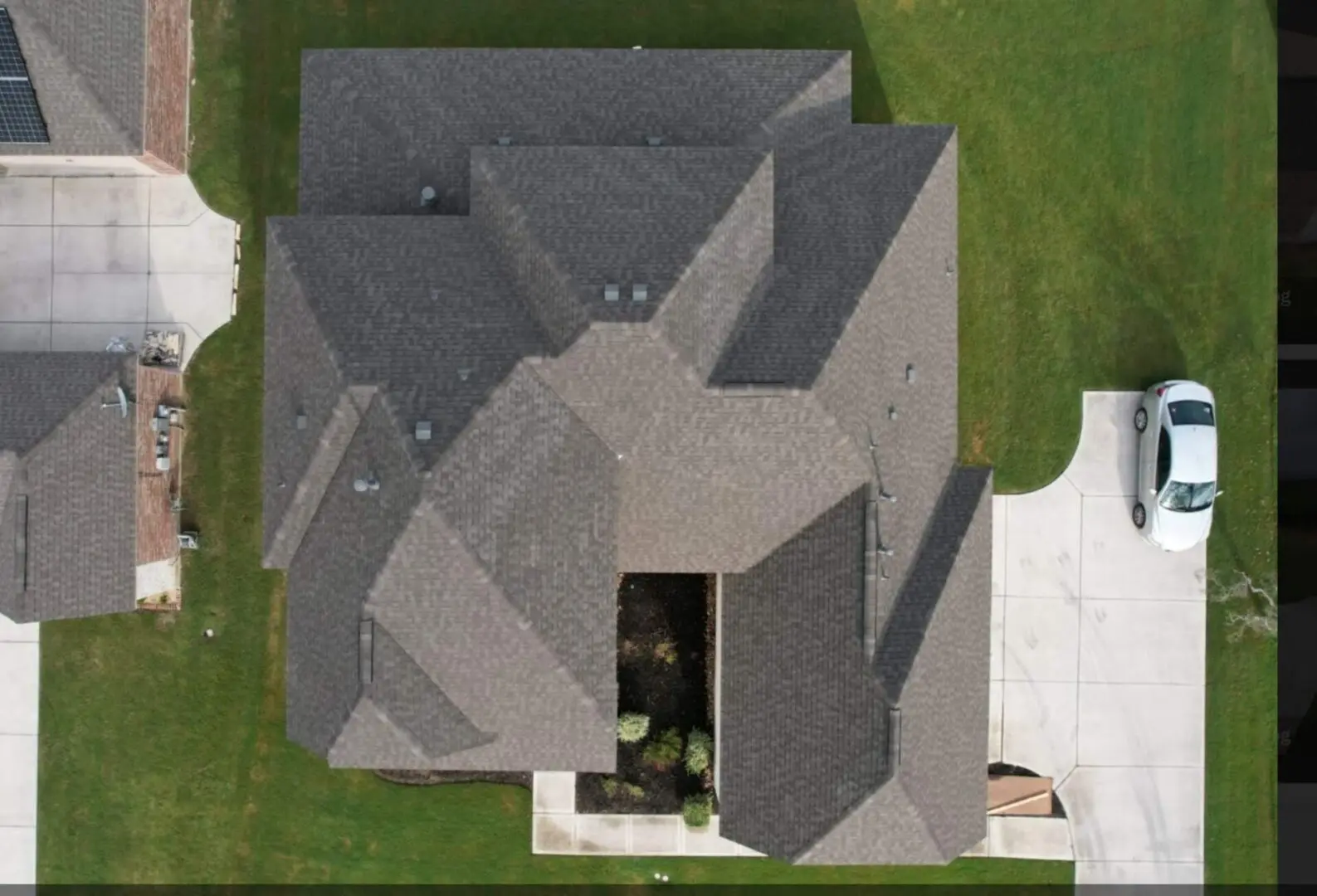 A bird 's eye view of a house with a dog in the yard.