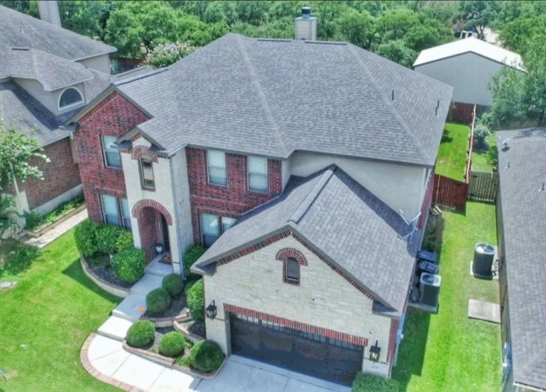 A large house with a lot of trees in the background