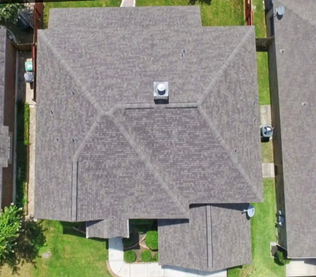 A bird 's eye view of a house with a car parked on the roof.