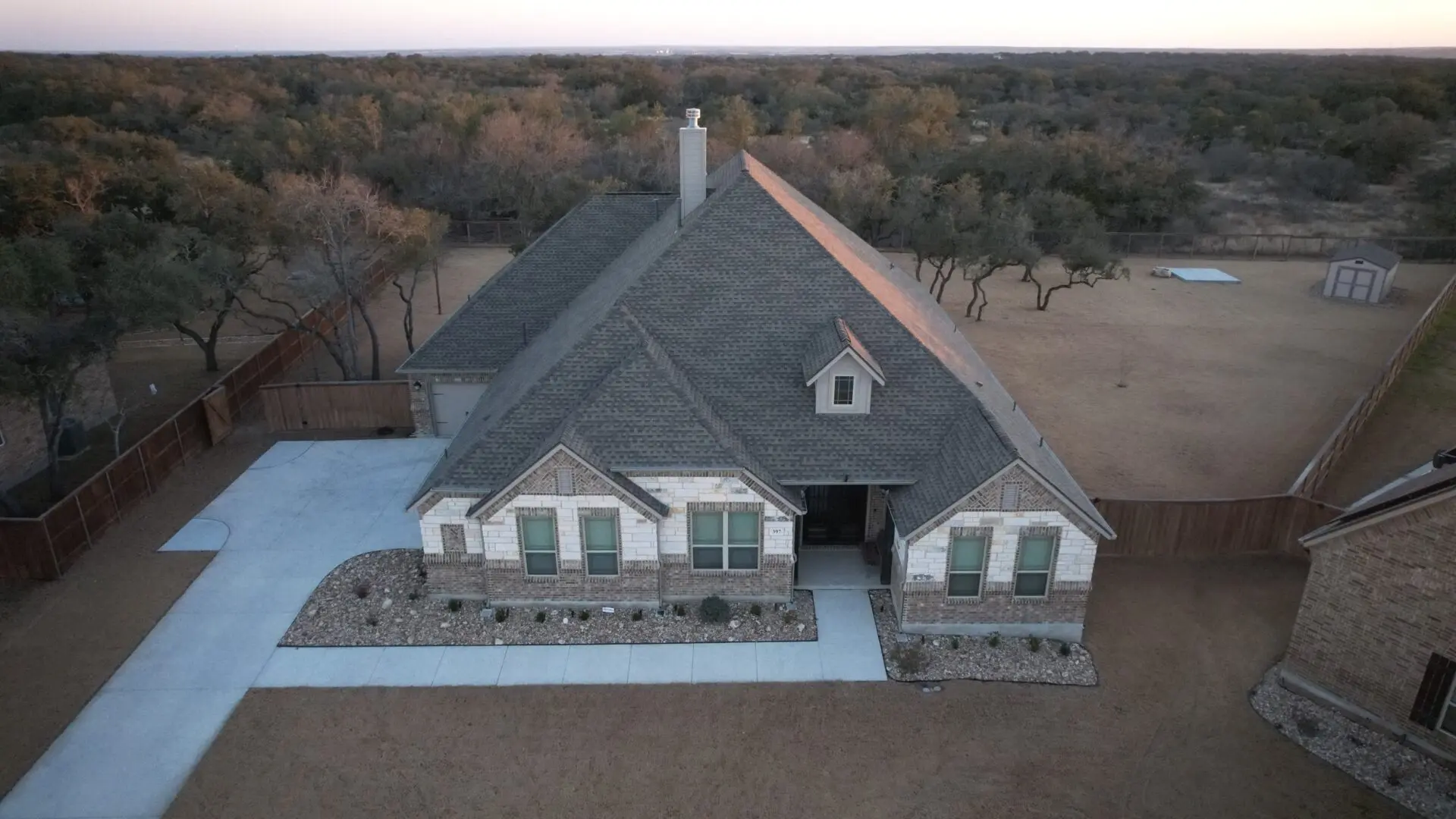 A house with a lot of windows and a roof that is not in the ground.