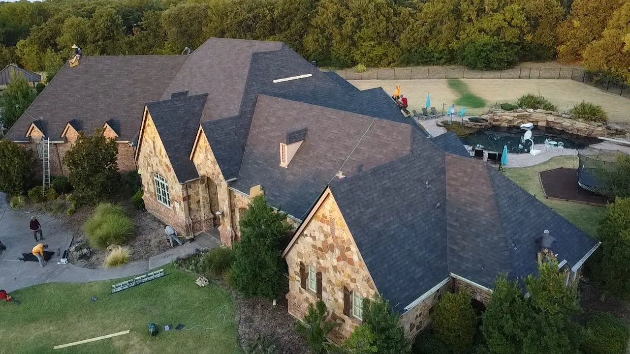 A large house with many windows and a lot of trees