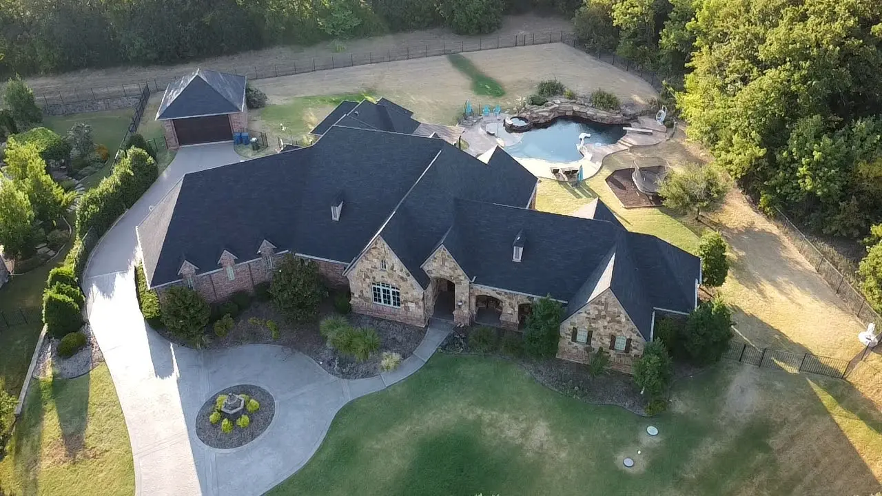 A large house with a pool and a lot of grass