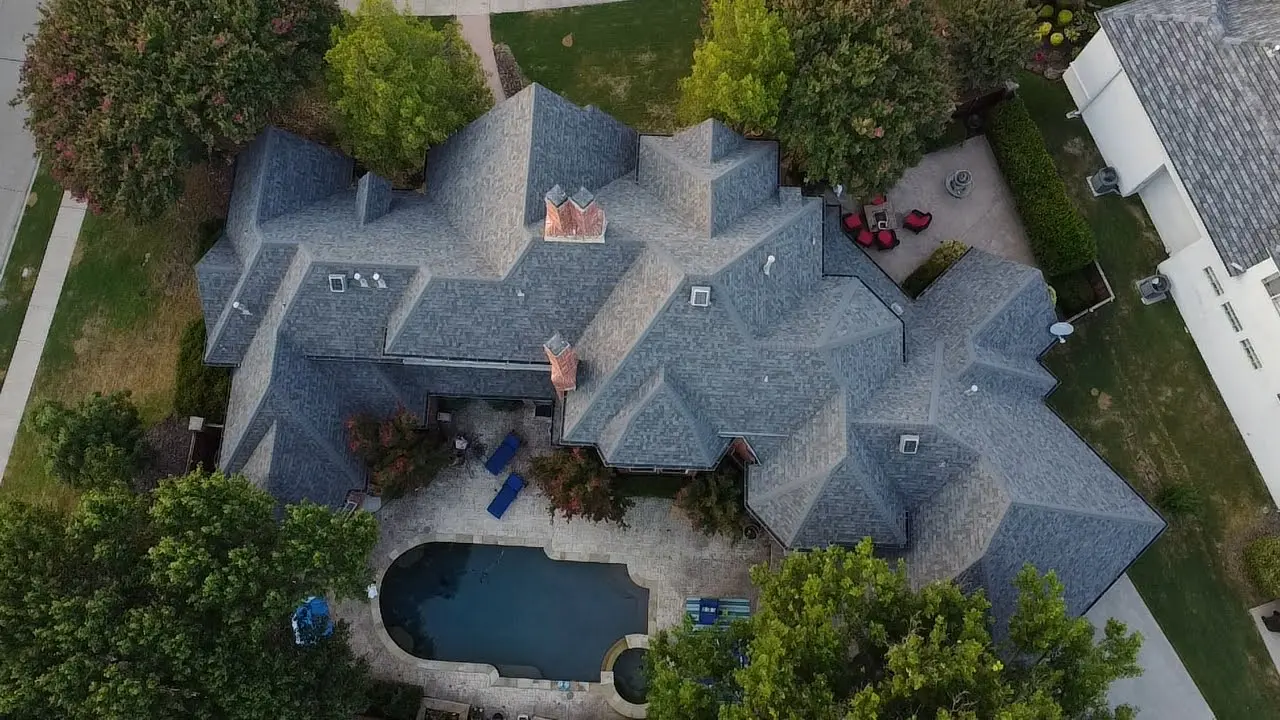 A bird 's eye view of a house with a pool.