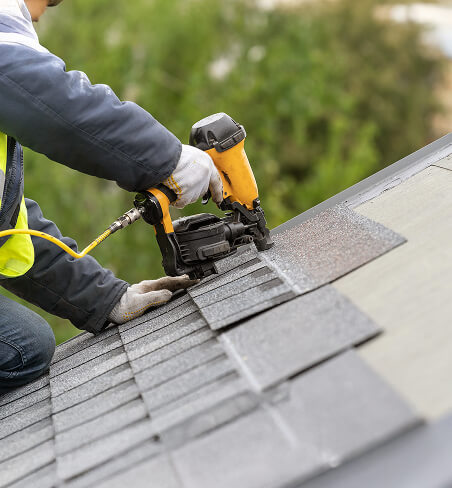 workman-using-pneumatic-nail-gun-install-tile-roof-new-house-construction-img